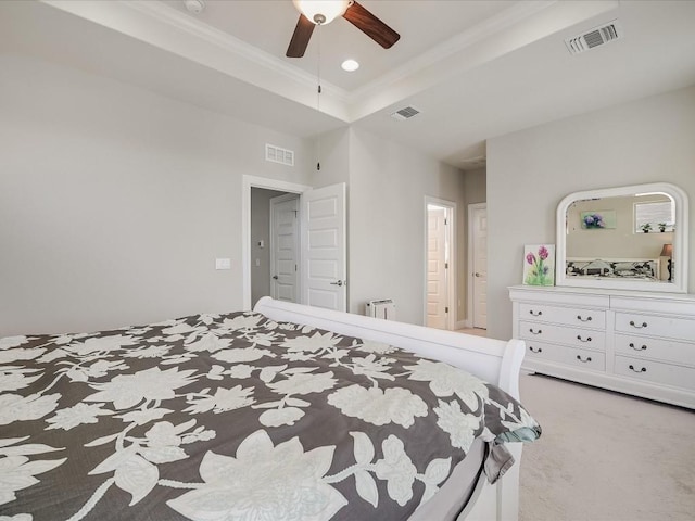 carpeted bedroom featuring a tray ceiling, visible vents, and radiator