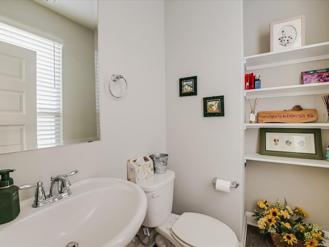 half bath with a sink and toilet