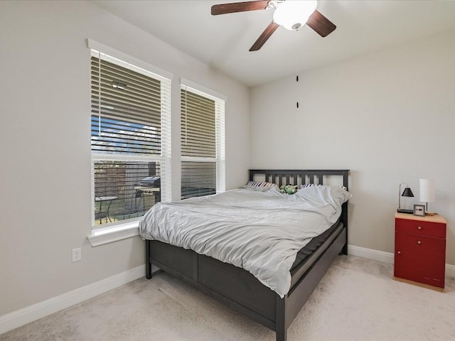 bedroom featuring ceiling fan, light colored carpet, and baseboards