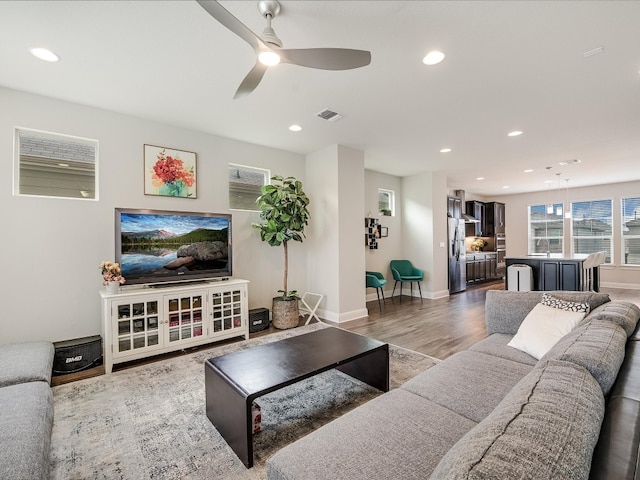 living room featuring ceiling fan and hardwood / wood-style floors