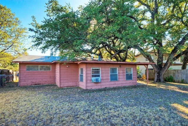 view of front of property with cooling unit and a front yard