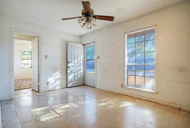 interior space with ceiling fan