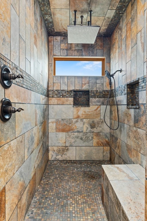 bathroom with tile walls and a tile shower