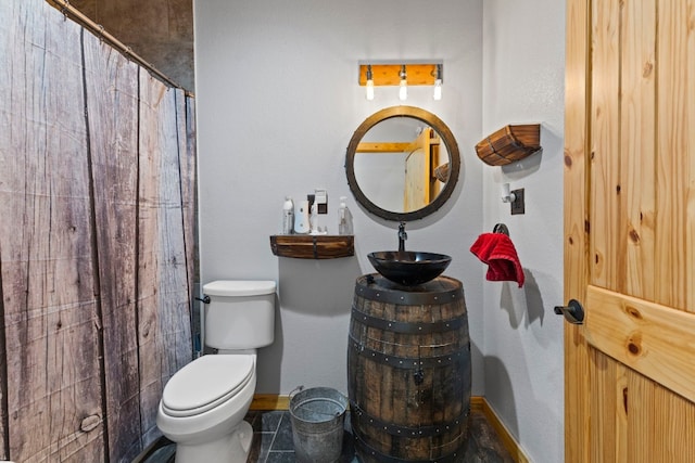 bathroom featuring toilet, vanity, a shower with shower curtain, and tile patterned floors