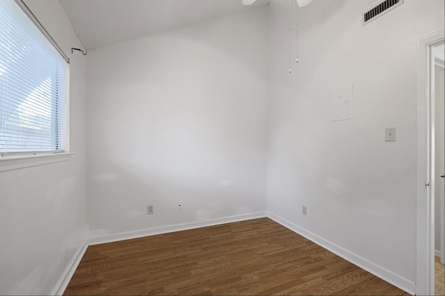 empty room featuring ceiling fan and dark hardwood / wood-style flooring