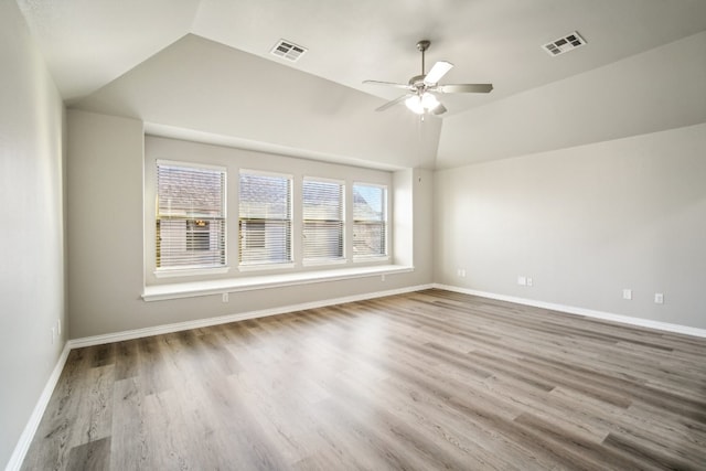 unfurnished room with ceiling fan, wood-type flooring, and vaulted ceiling