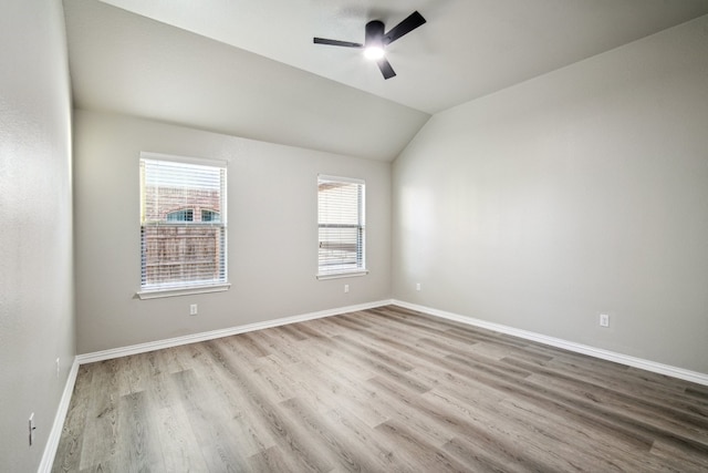 empty room with ceiling fan, light hardwood / wood-style flooring, and lofted ceiling