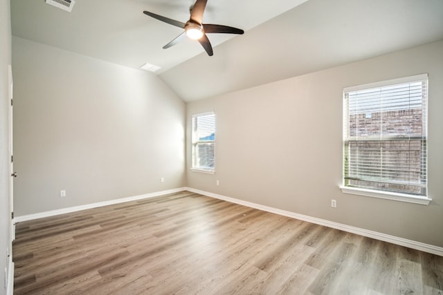 unfurnished room with light wood-type flooring, plenty of natural light, and lofted ceiling