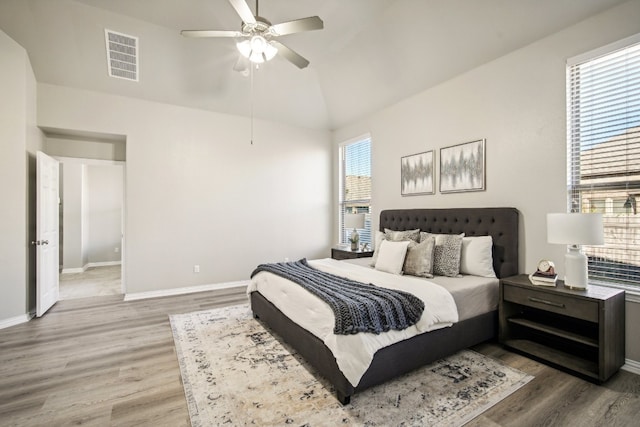 bedroom with multiple windows, hardwood / wood-style floors, and ceiling fan