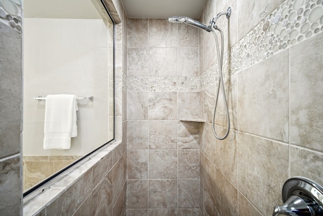 bathroom with tiled shower