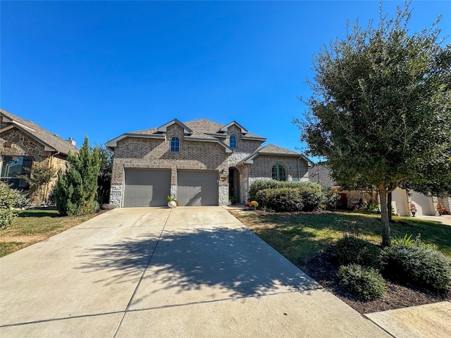 view of front of property featuring a garage and a front lawn