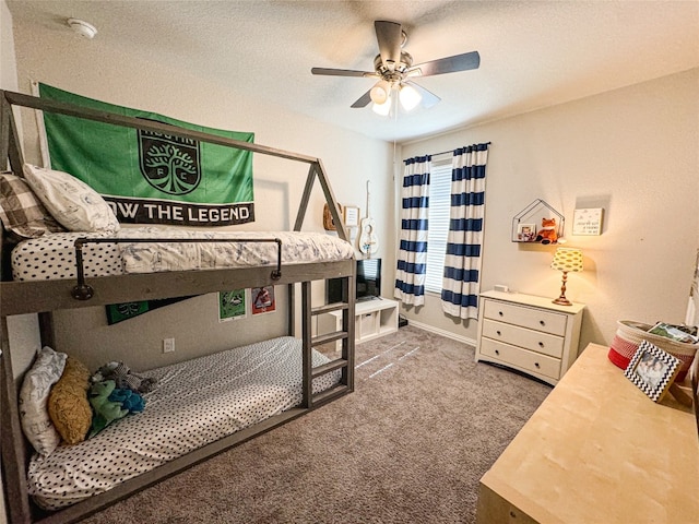 bedroom featuring a textured ceiling, carpet floors, and ceiling fan