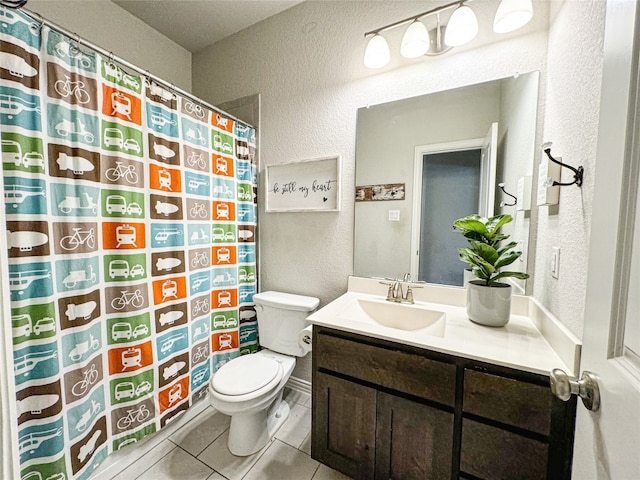 bathroom featuring toilet, vanity, and tile patterned flooring