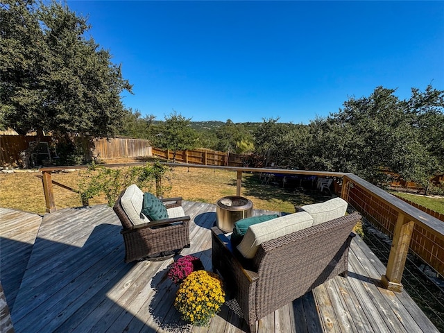 wooden terrace with a lawn and an outdoor living space