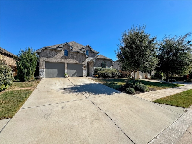 view of front of house with a garage and a front yard