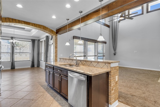 kitchen featuring dark brown cabinetry, a wealth of natural light, sink, and dishwasher