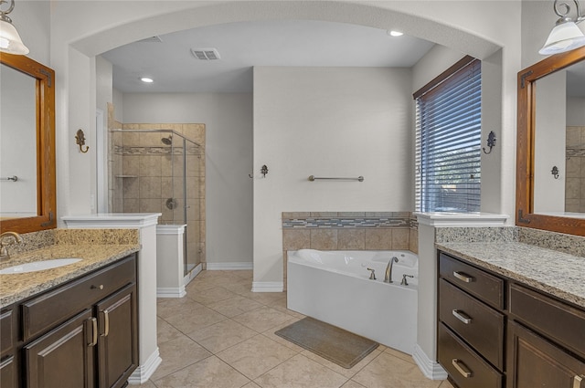 bathroom featuring shower with separate bathtub, tile patterned floors, and vanity