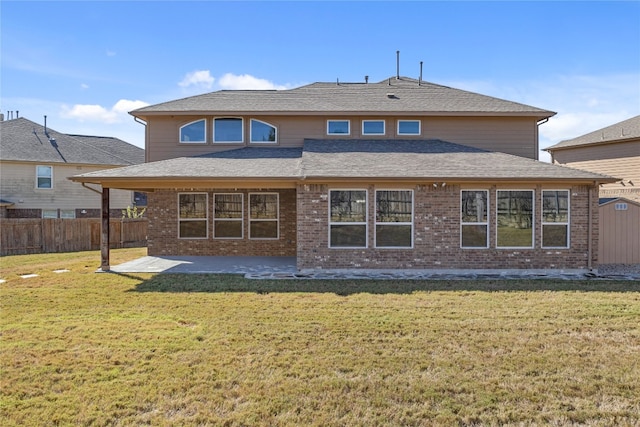 back of property featuring a shed, a lawn, and a patio