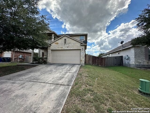 view of front of property with a garage and a front yard