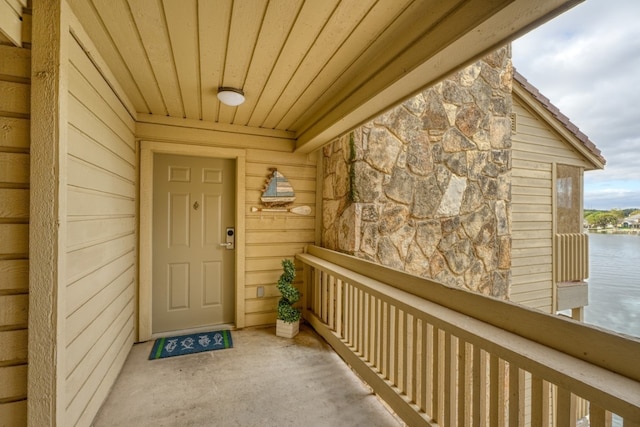 doorway to property featuring a water view and a balcony