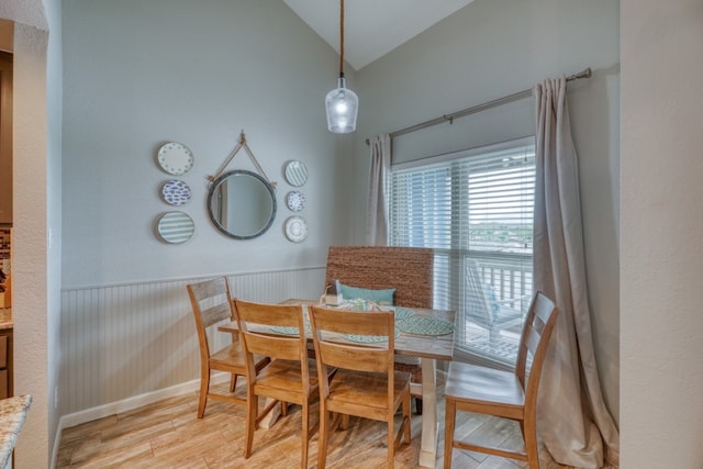 dining space featuring light hardwood / wood-style flooring and lofted ceiling