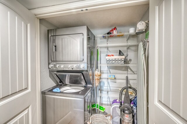 laundry area with stacked washer and clothes dryer