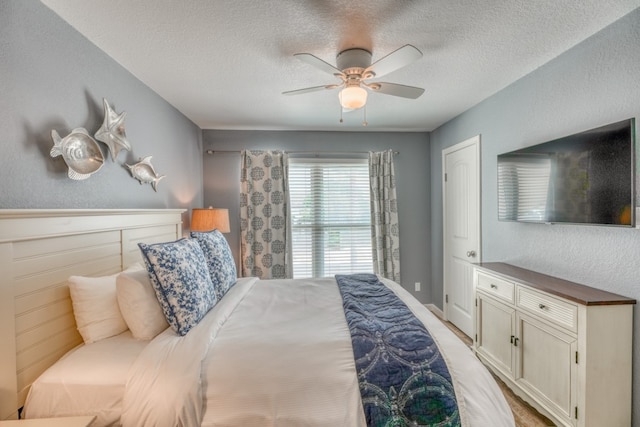 bedroom with a textured ceiling and ceiling fan