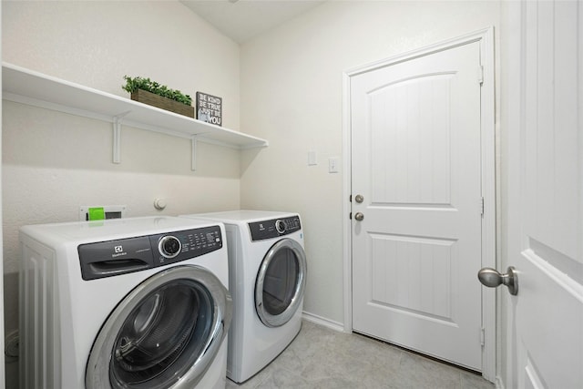 clothes washing area with washing machine and dryer