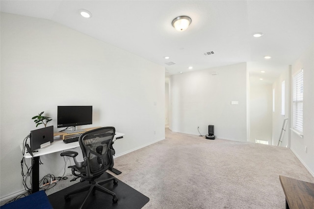 carpeted office space featuring lofted ceiling