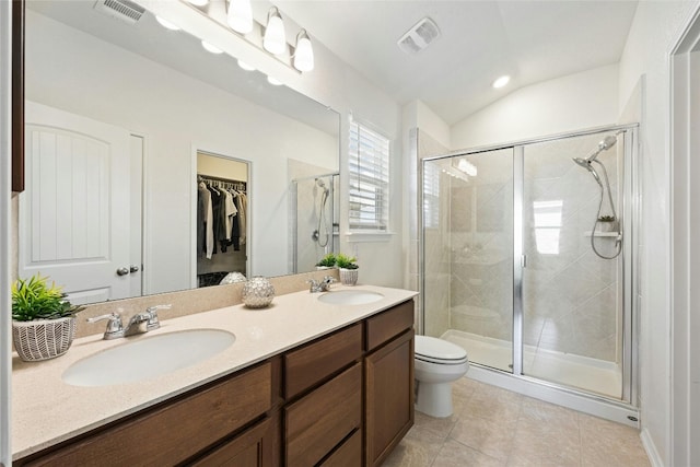 bathroom featuring walk in shower, vanity, lofted ceiling, tile patterned floors, and toilet