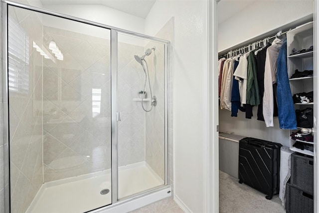 bathroom featuring a shower with door