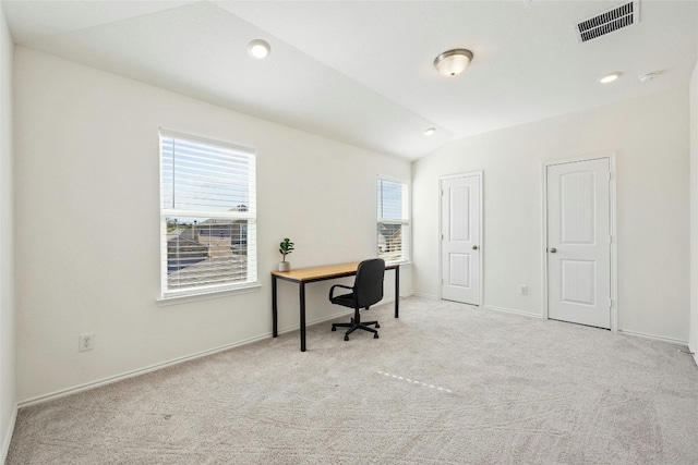 office area with light colored carpet and vaulted ceiling