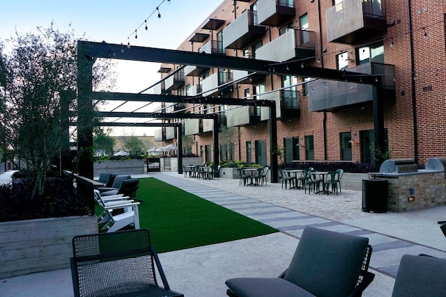 view of home's community featuring an outdoor kitchen and a patio area