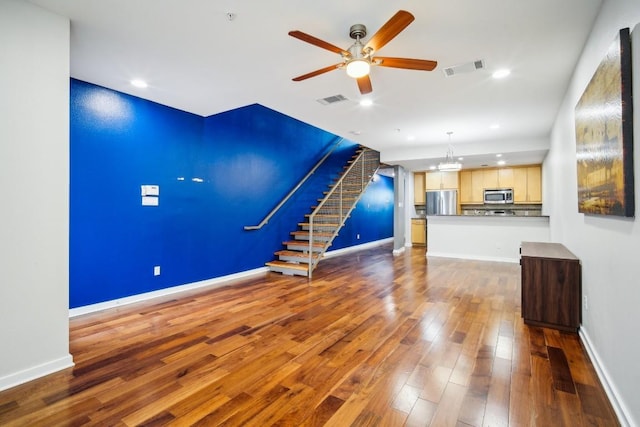 503 Swanee Dr Unit 19, Austin, TX 78752 - unfurnished living room featuring a ceiling fan, wood finished floors, stairs, and recessed lighting