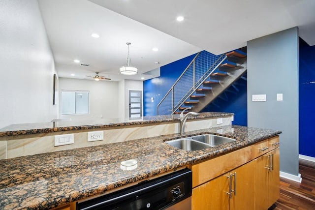 kitchen featuring dark wood-type flooring, dark stone counters, sink, ceiling fan, and dishwashing machine