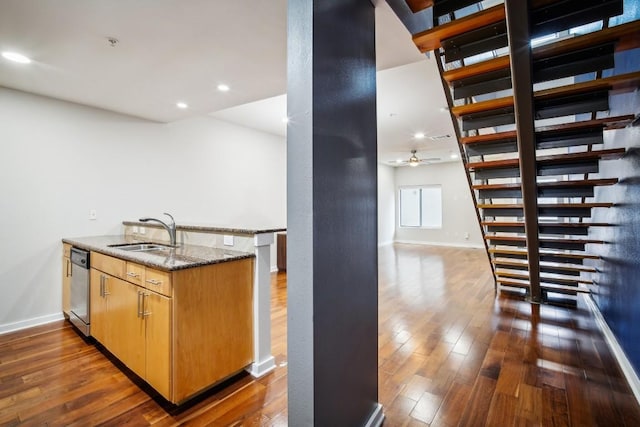 503 Swanee Dr Unit 19, Austin, TX 78752 - kitchen featuring dark stone counters, dark wood-style floors, dishwasher, and recessed lighting