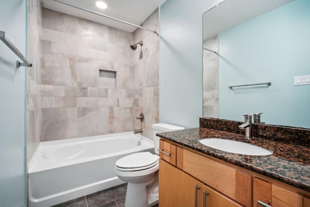 full bathroom featuring tile patterned floors, tiled shower / bath combo, toilet, and vanity