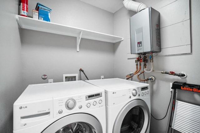 washroom featuring washer and clothes dryer and water heater