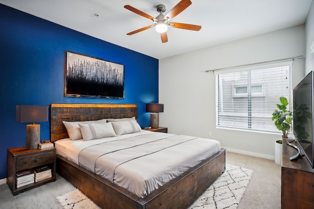 bedroom with ceiling fan and light colored carpet