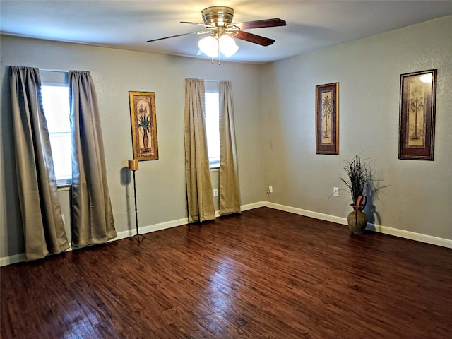 empty room with ceiling fan and dark hardwood / wood-style flooring