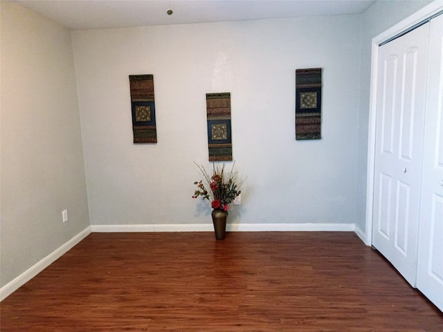 empty room with dark hardwood / wood-style flooring