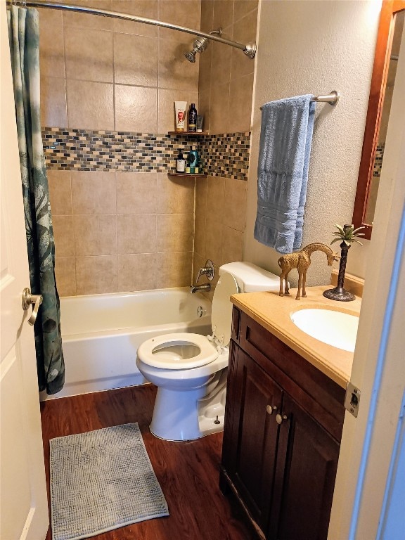 full bathroom with toilet, vanity, shower / bath combo with shower curtain, and hardwood / wood-style floors