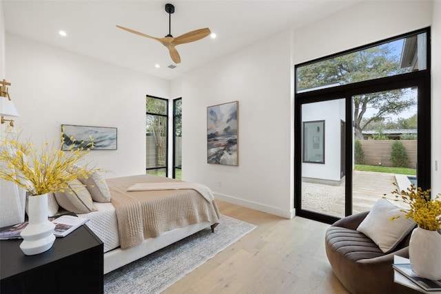 bedroom with ceiling fan, light wood-type flooring, access to outside, and multiple windows