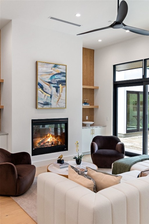 living room with hardwood / wood-style flooring and ceiling fan