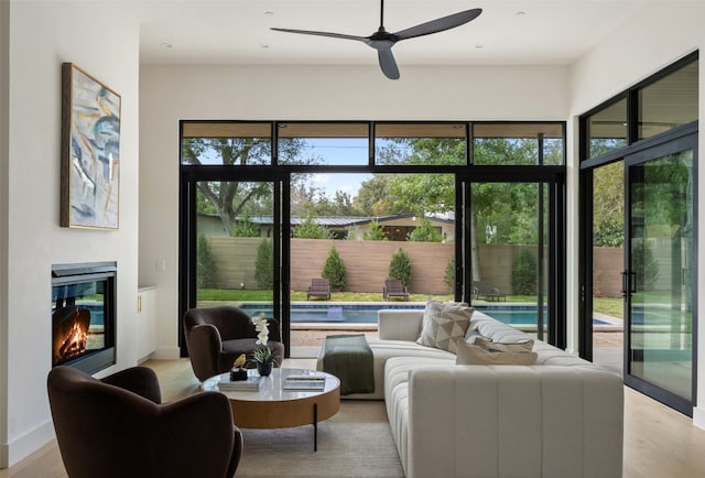 interior space with ceiling fan and light hardwood / wood-style floors