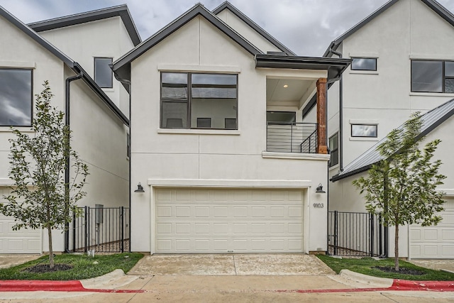 view of front facade with a garage and a balcony