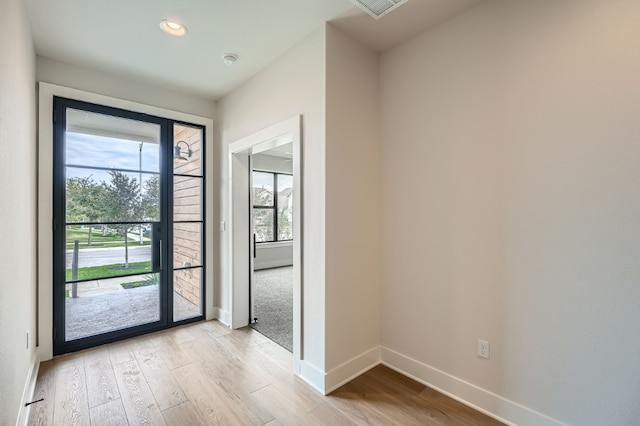 doorway to outside with light hardwood / wood-style floors