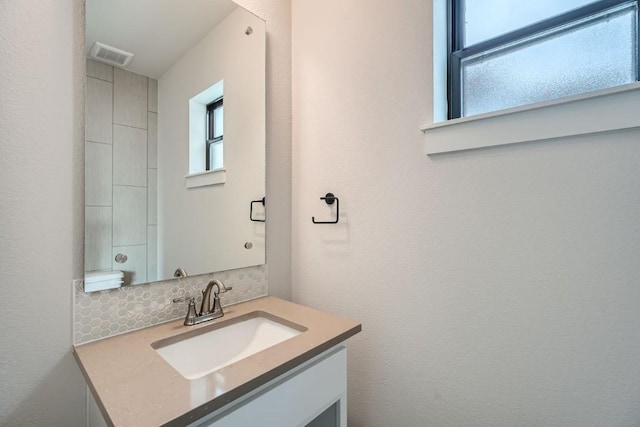 9103 Cattle Baron Path, Austin, TX 78747 - bathroom featuring vanity and tasteful backsplash