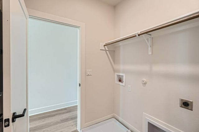 9103 Cattle Baron Path, Austin, TX 78747 - laundry area with electric dryer hookup, light wood-style floors, hookup for a washing machine, gas dryer hookup, and baseboards