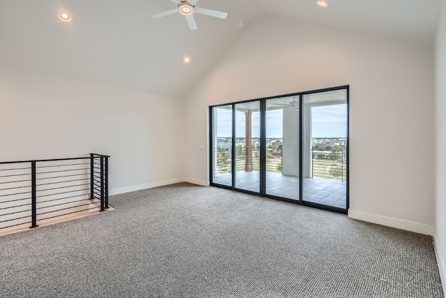 spare room with ceiling fan, high vaulted ceiling, and carpet